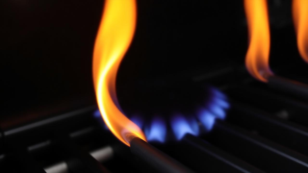 Burner tube with yellow flame indicating dirt or clogged ports